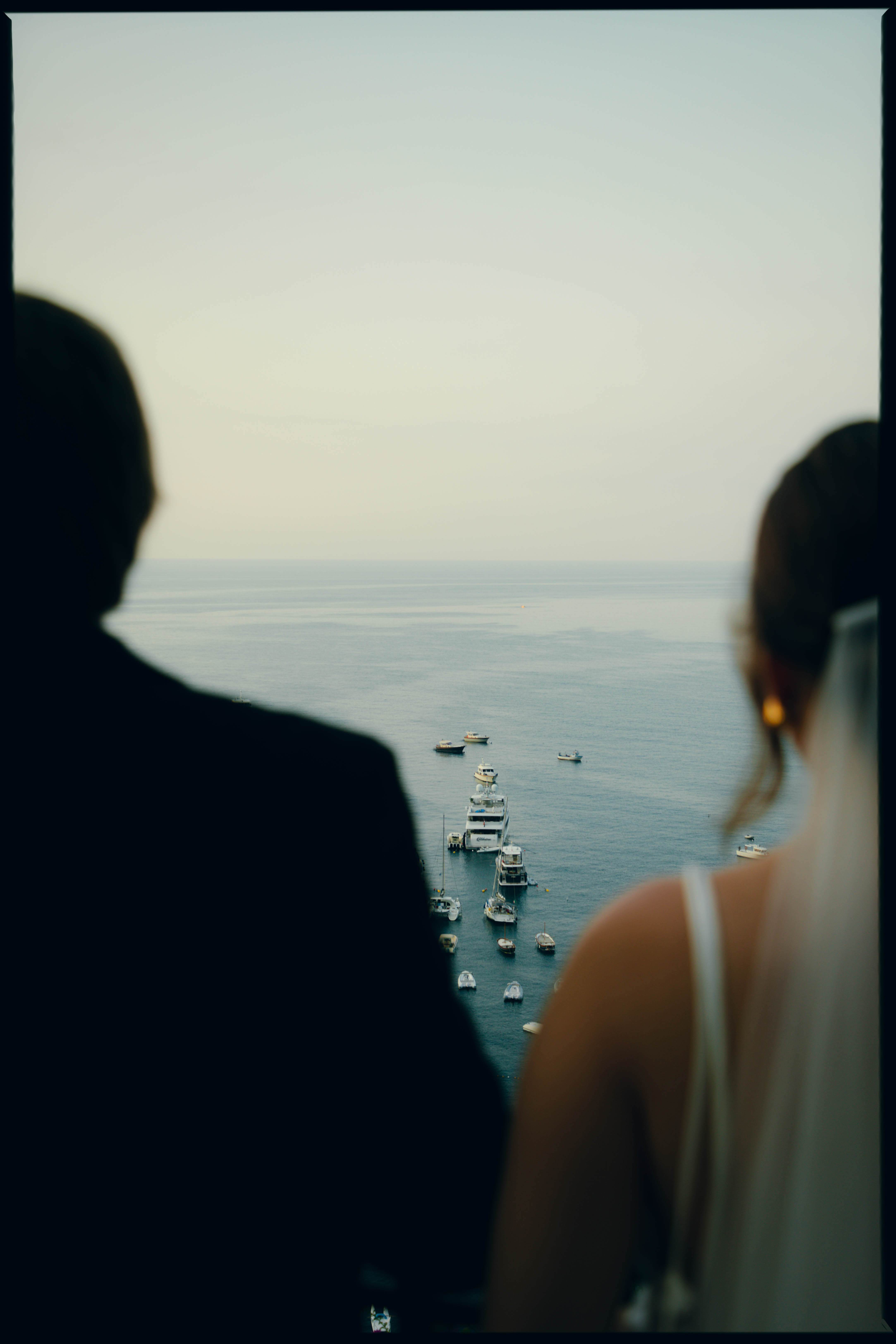 Couple looking out over the sea from a terrace in Positano, shot on film