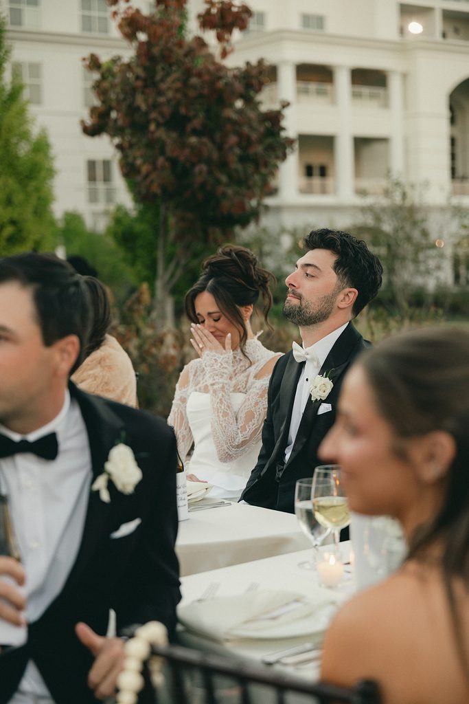 Bride tearing up during toasts at the wedding reception dinner